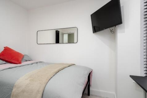 Cozy double bedroom featuring soft bedding and ...