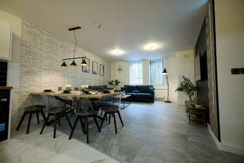 A modern and spacious living room featuring a l...