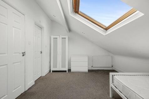 A bright and tidy double bedroom featuring a sl...