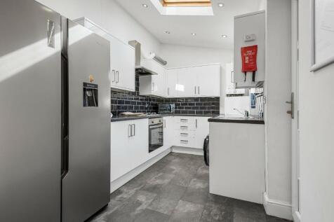 Bright and modern kitchen with sleek white cabi...