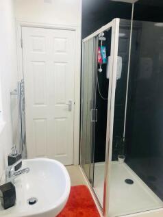 A modern bathroom featuring a clear glass showe...