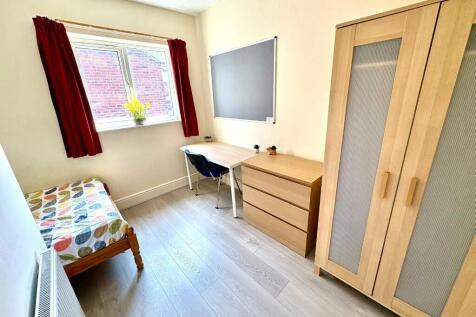 Bright and tidy single bedroom featuring a wind...