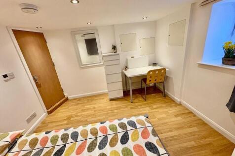 A neat and bright bedroom featuring a colorful ...