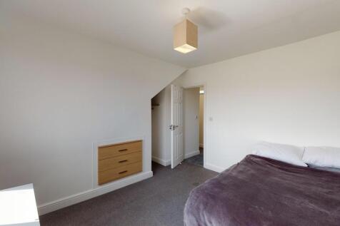 Bright and spacious master bedroom featuring a ...