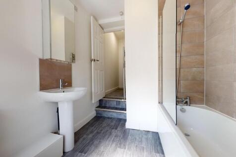 Bright and modern bathroom featuring a clean wh...