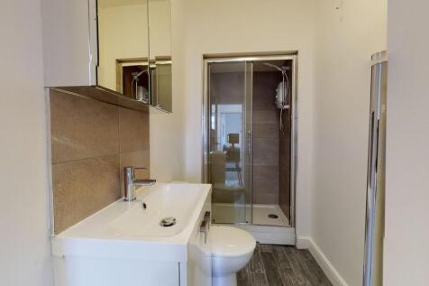 A modern bathroom featuring a clean white sink ...