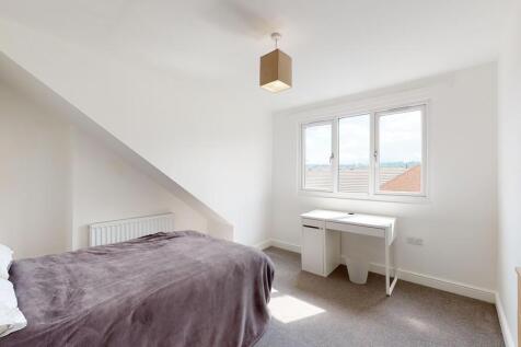 Bright and tidy bedroom featuring a cozy single...