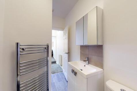 Bright and modern bathroom featuring a sleek va...