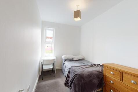 Cozy single bedroom with a comfortable bed, a s...