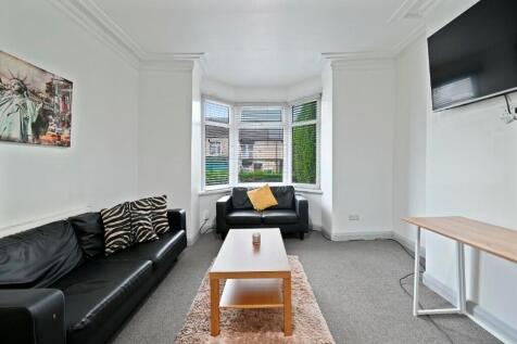 Bright and contemporary living room featuring a...