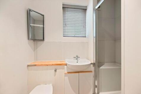A compact and clean bathroom featuring a white ...