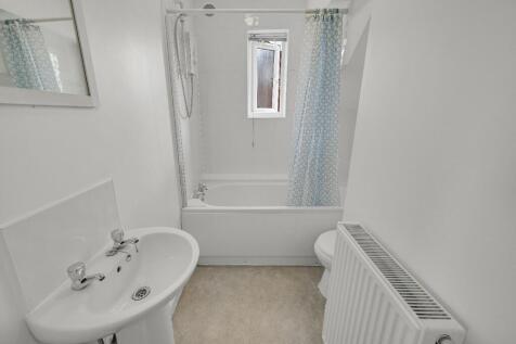 Bright and clean bathroom featuring a white sin...