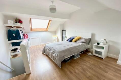 A bright and spacious master bedroom featuring ...