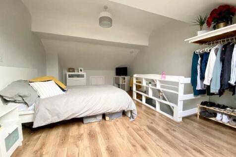 A bright and spacious master bedroom featuring ...