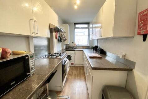 Bright and modern galley kitchen with ample cou...