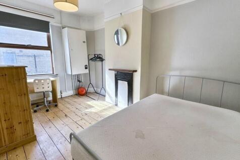 Bright and airy double bedroom featuring a comf...