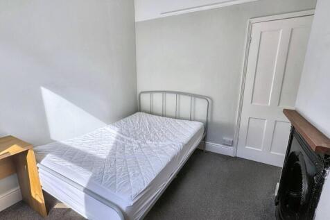 A bright double bedroom featuring a neat metal ...