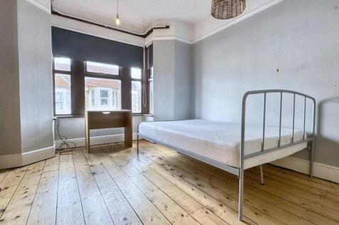 Bright and airy single bedroom featuring a larg...