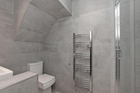 A modern and stylish bathroom featuring sleek g...