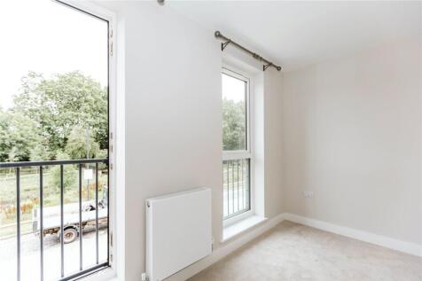 A bright and airy double bedroom featuring larg...