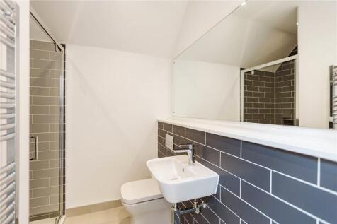 Bright and modern bathroom featuring a spacious...