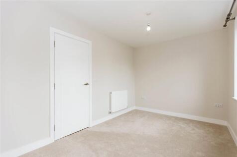 A clean, minimalistic small room with neutral t...