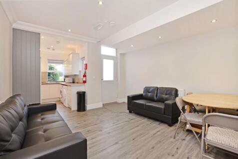 A modern living room featuring comfortable blac...