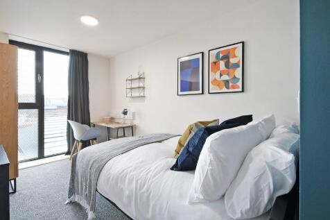 A bright and spacious master bedroom featuring ...