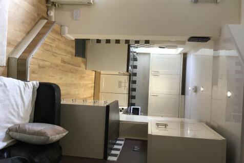A modern kitchen featuring clean white cabinets...