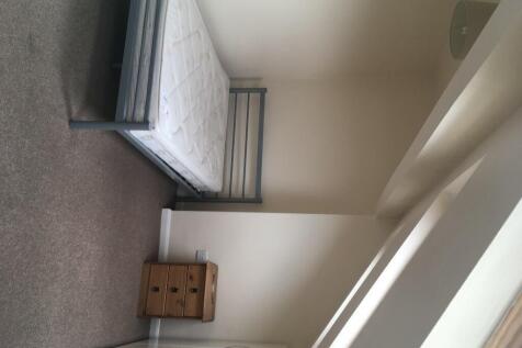 A bright and tidy single bedroom featuring a si...