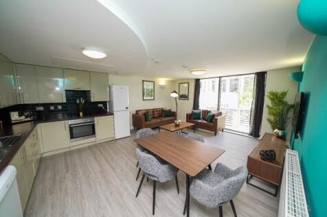 A spacious and modern open-plan living area fea...