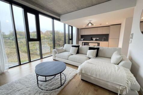 A bright and modern living room featuring floor...
