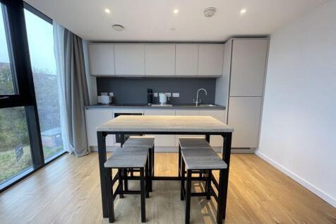 Bright and modern kitchen featuring sleek cabin...