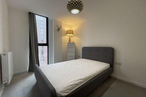 A neat and modern double bedroom featuring a la...