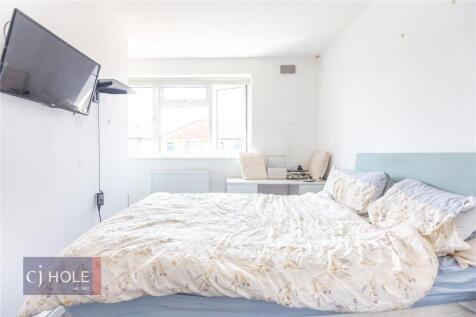 Bright and airy master bedroom featuring a larg...