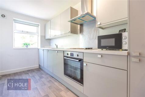 Bright and modern kitchen featuring sleek grey ...