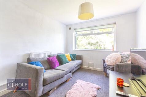 A cozy living room featuring a comfortable grey...