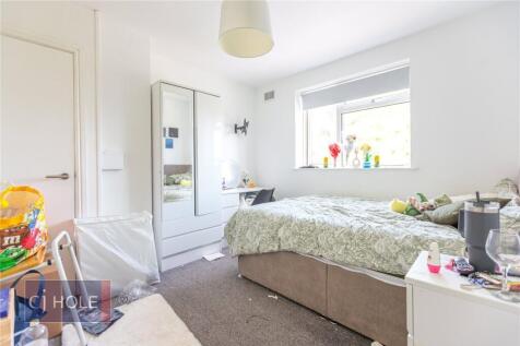 A cozy and tidy single bedroom with a large win...