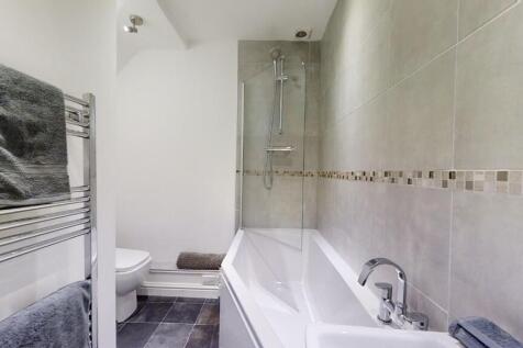 A modern bathroom suite featuring a spacious ba...
