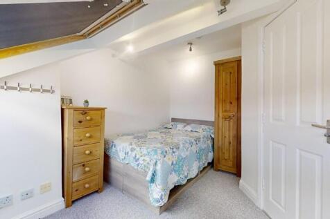 Bright and cozy double bedroom featuring a comf...