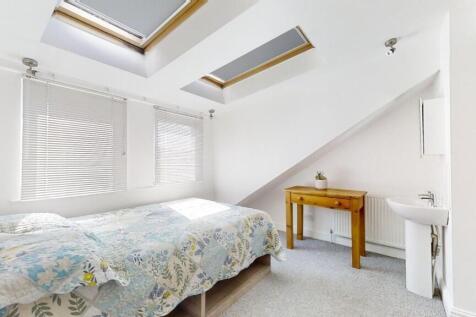 Bright and cozy double bedroom featuring skylig...
