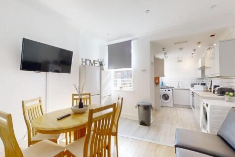 Bright and modern kitchen and dining area featu...