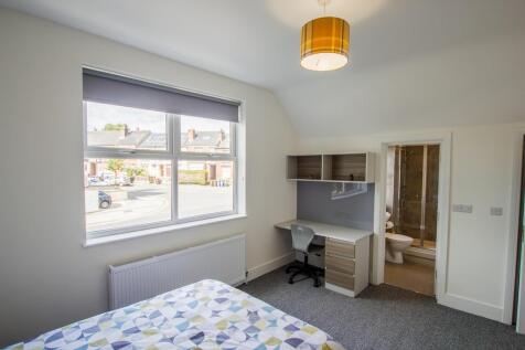 Bright and spacious master bedroom featuring a ...