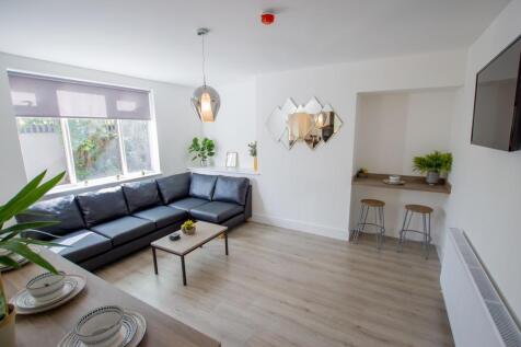 Bright and modern living room featuring a spaci...