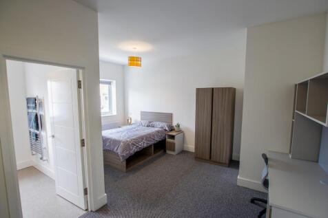 Bright and spacious master bedroom featuring a ...