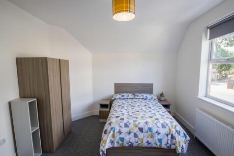 A bright and tidy double bedroom featuring a co...