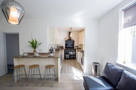 Bright and modern kitchen with a breakfast bar,...