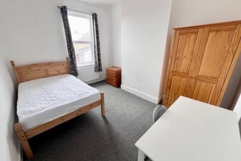 Bright and tidy double bedroom featuring a comf...