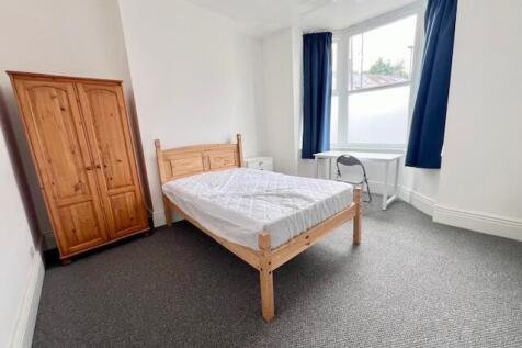 Bright and airy double bedroom featuring a wood...