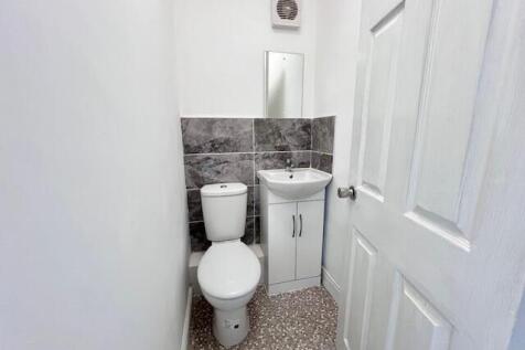 A clean and modern single toilet room featuring...
